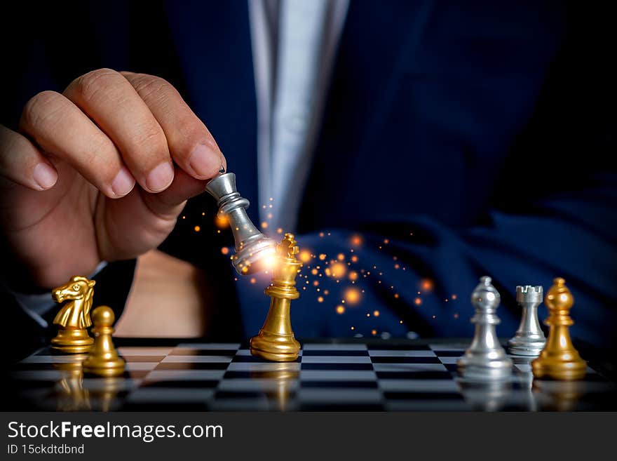 Businessman playing golden chess for strategy business plan