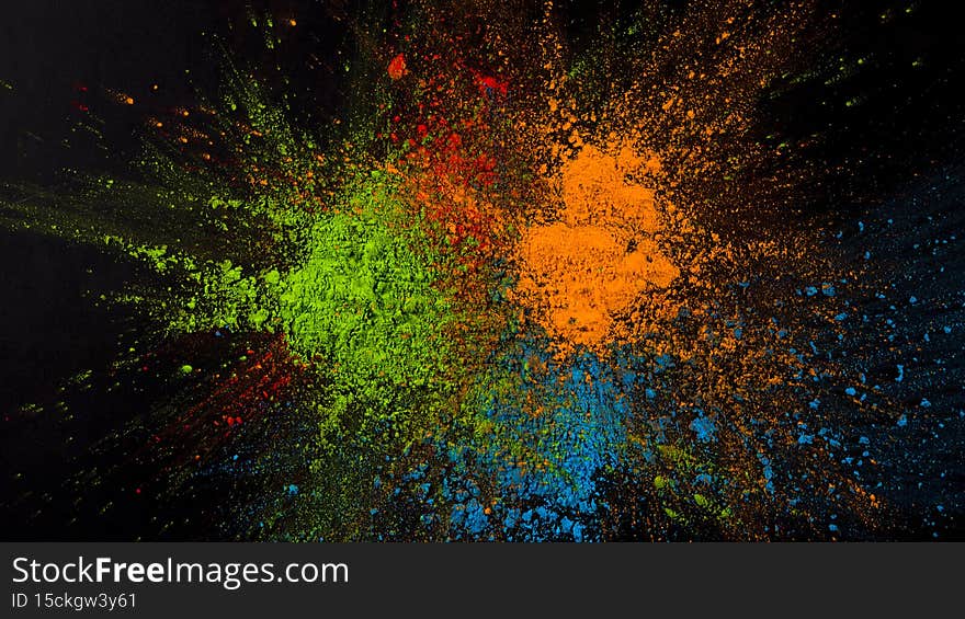 splatted green blue orange color black background. High quality photo
