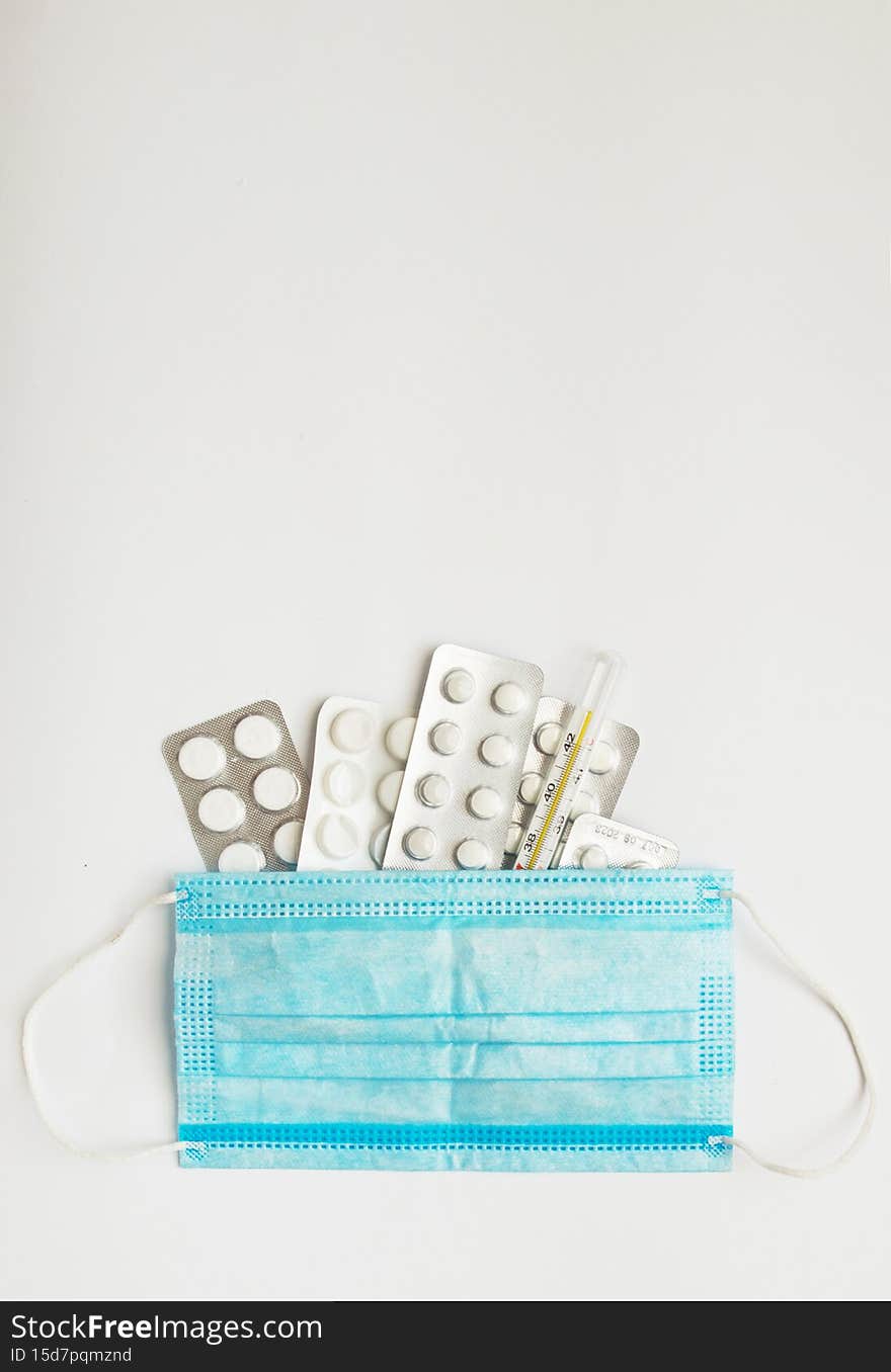 Close-up of medical mercury thermometer and protective mask. medicine and Diseases and Treatment.