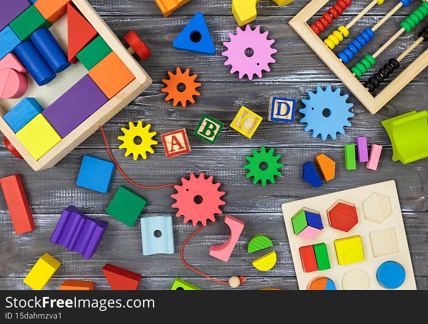 Multicolored fractions, blocks, notebook on a gray wooden table. Back to school, fun math, games for kindergarten, preschool