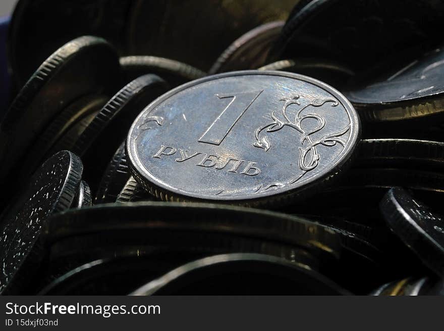 Russian 1 ruble coin reverse against the background of other Russian rubles