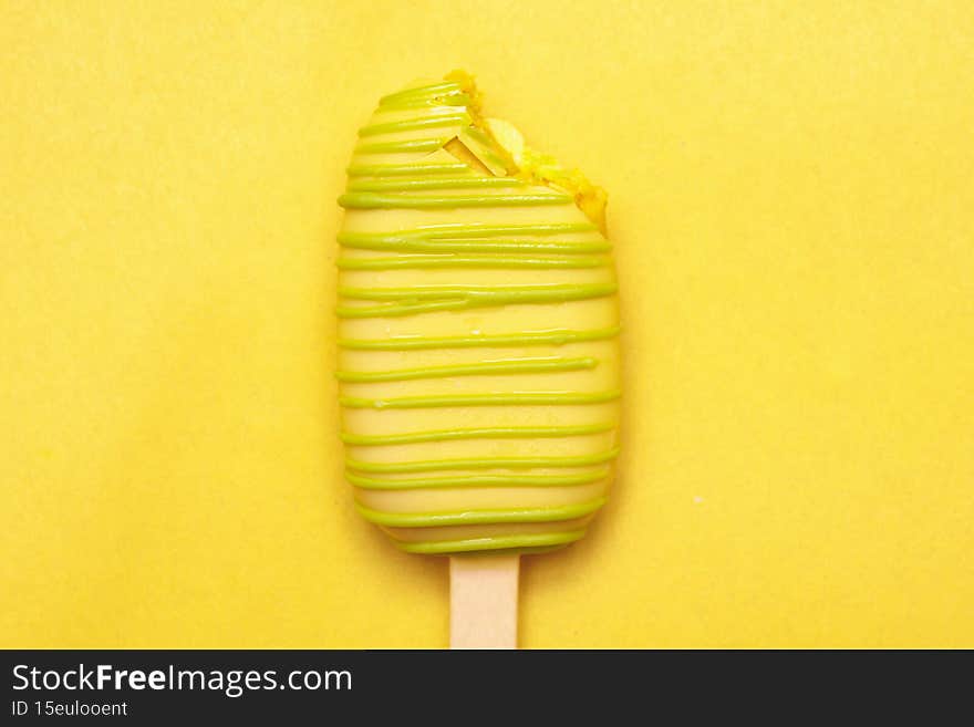 yellow chocolate glaze isolated on yellow background, copy space right