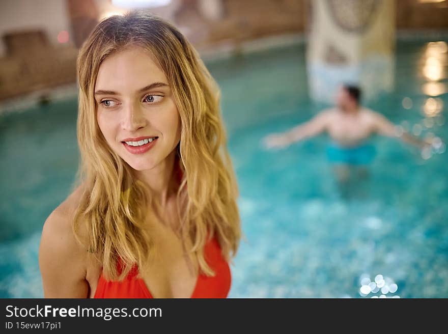 Swimming pool. A pretty young women and her boyfriend spending time in a pool in spa center. Swimming pool. A pretty young women and her boyfriend spending time in a pool in spa center