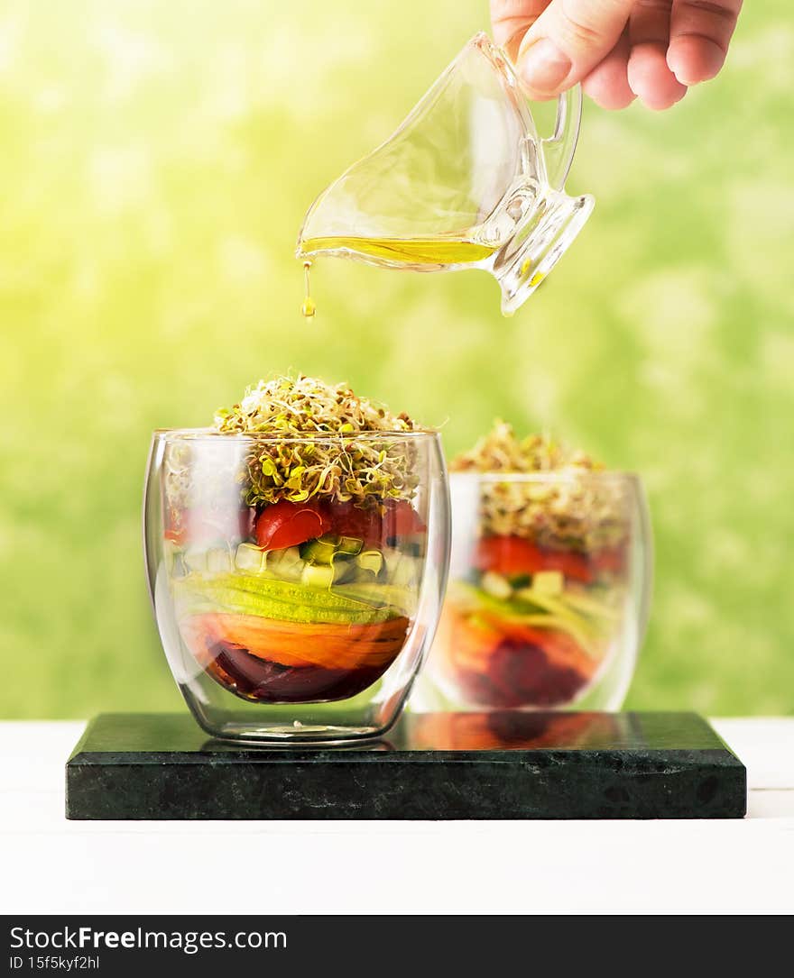 Salad in glass with microgreens and fresh vegetables. Healthy food, diet, detox, clean eating and vegetarian concept