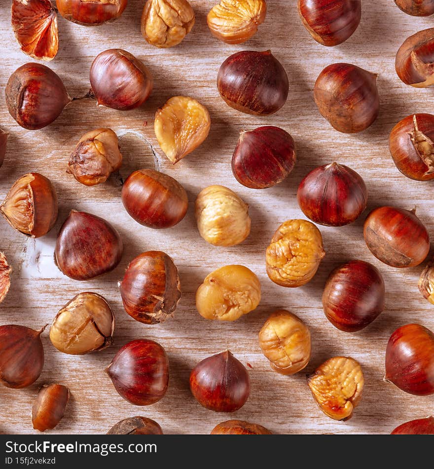 Cooked chestnuts, square shot from the top on a rustic wooden background. Healthy vegan autumn food