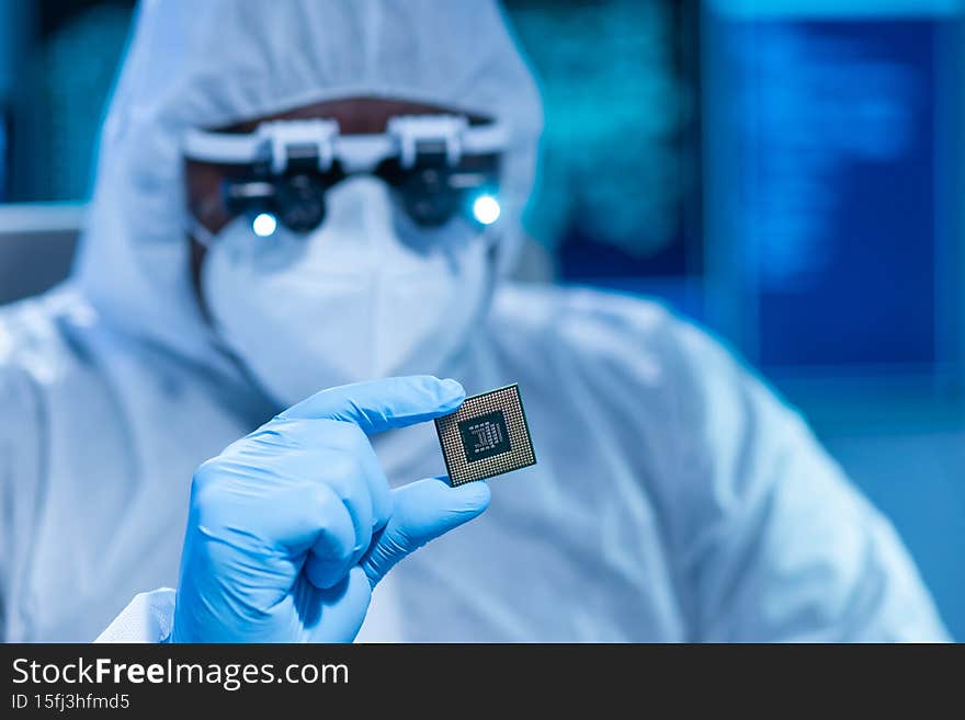 Professional African-American scientist works in a modern scientific laboratory for the research and development of microelectronics and processors. Microprocessor manufacturing worker uses computer technology and equipment.