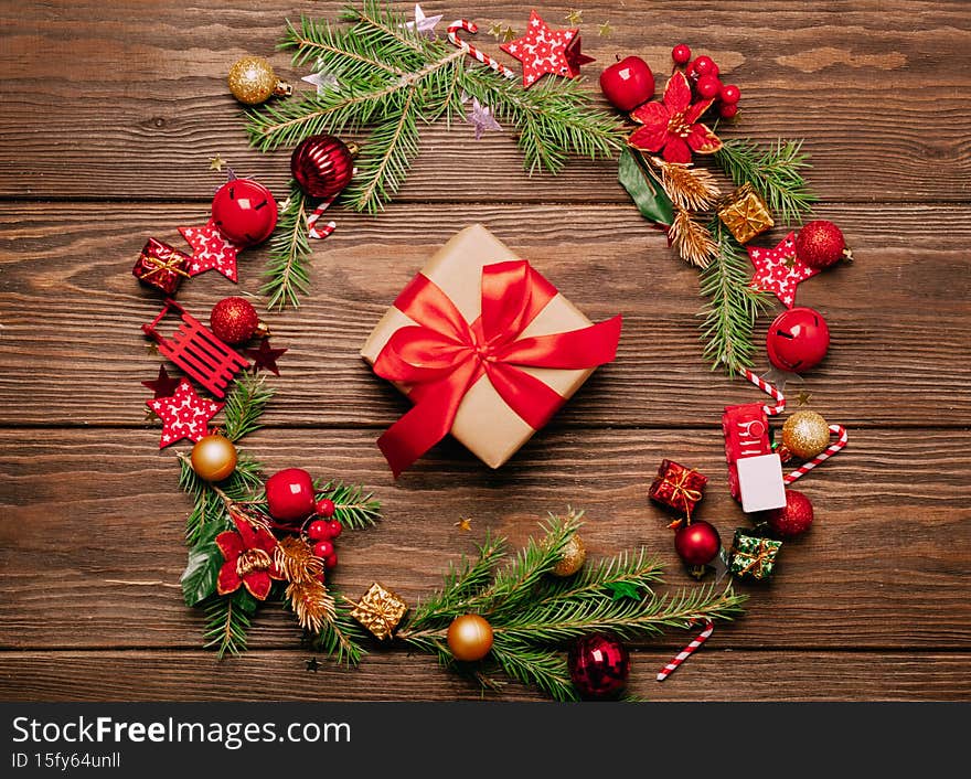 Christmas festive layout wreath spruce branches red toys gift red ribbon serpentine. Mockup card for Christmas New Year