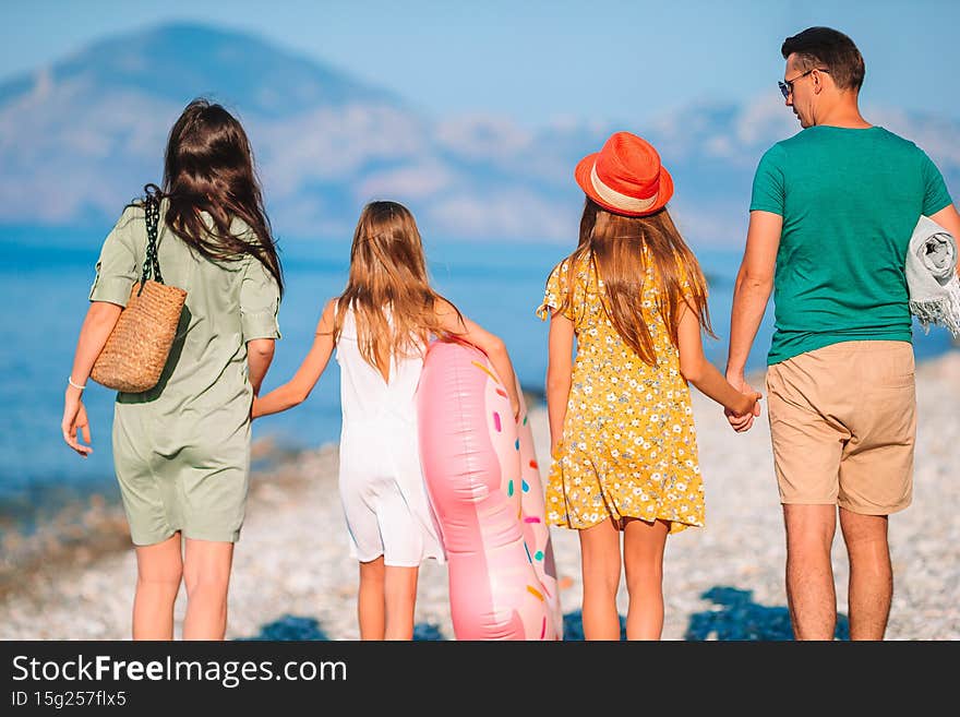 Photo of happy family having fun on the beach. Summer Lifestyle