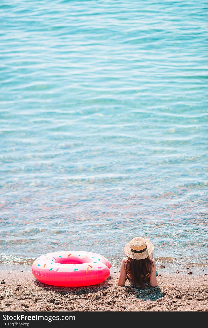 Young woman in hat on the beach vacation