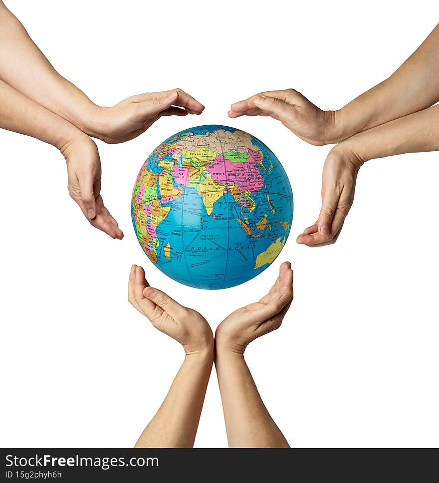 close op of hands around a globe earth on white background. close op of hands around a globe earth on white background