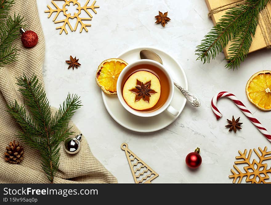 A cup of fragrant fruit tea on a Christmas background