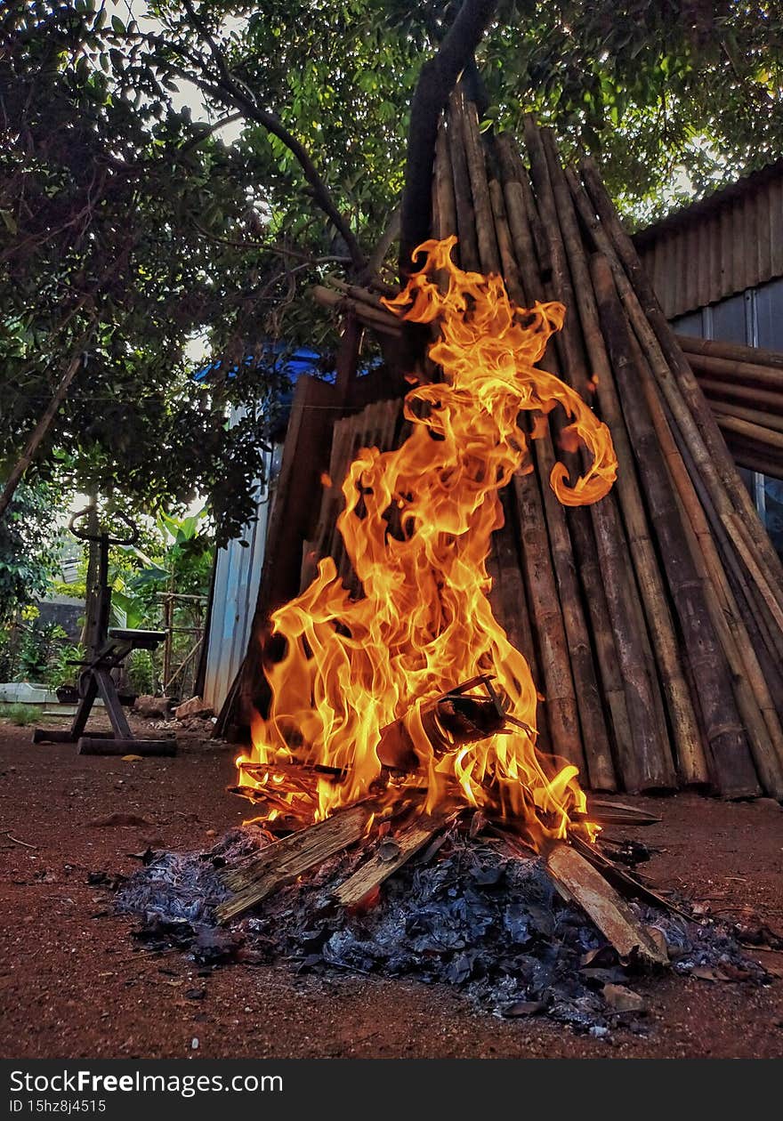 Bekasi Indonesia, November 9, 2021, A blazing fire burns garbage mixed with leaves and wood.