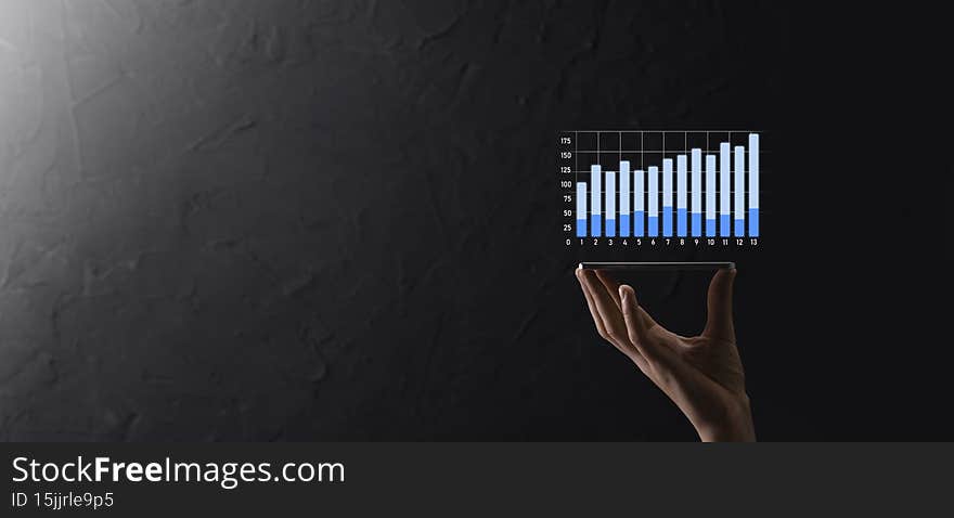 Businessman holding graph growth and increase of chart positive indicators in his business.Investment up concept.analyzing sales