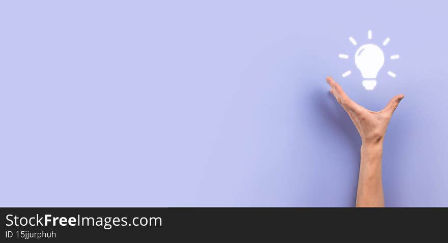 Hand hold light bulb. Holds a glowing idea icon in his hand. With a place for text.The concept of the business idea.Innovation, brainstorming, inspiration and solution concepts