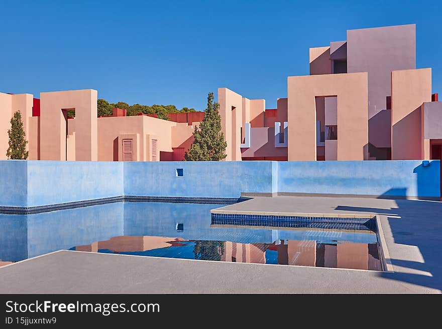 Geometric colored building with pool. Red wall, Calpe, Spain. Geometric colored building with pool. Red wall, Calpe, Spain