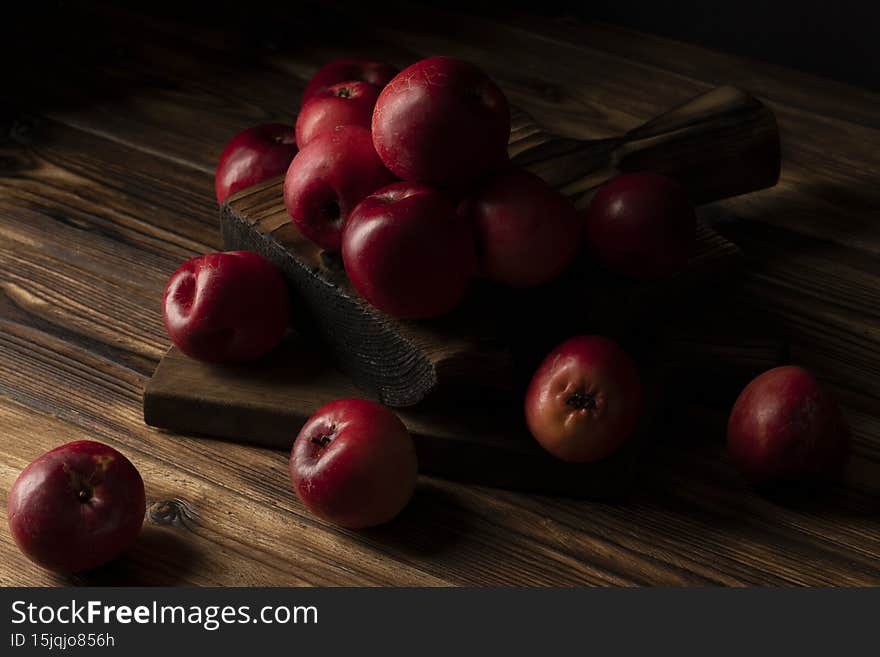 Fresh red apples on wooden table. On wooden background.