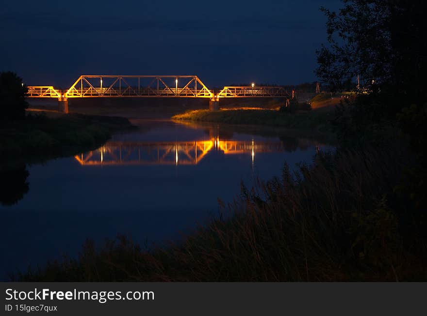 River Venta and railway bridge in summer night, Skrunda, Latvia.