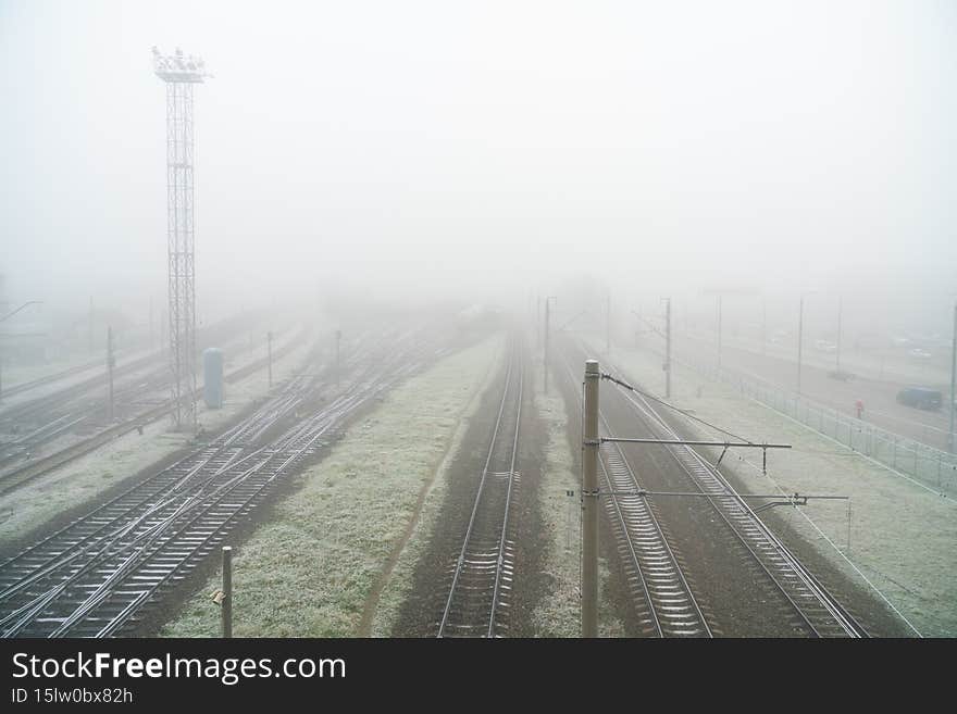 Foggy gray road, cars driving vanish into the fog. Foggy gray road, cars driving vanish into the fog