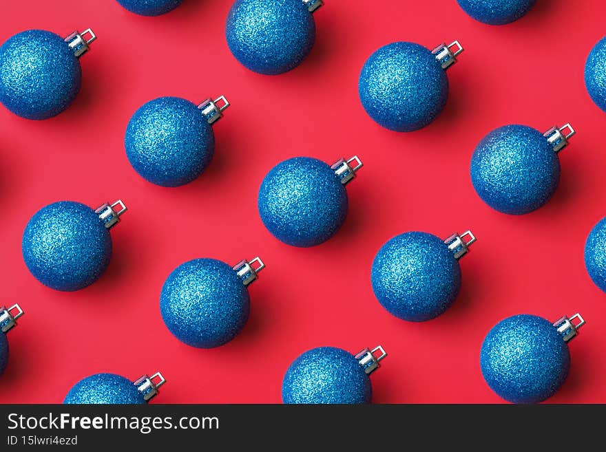 Blue Christmas ball bauble pattern minimal flatlay on red background top view