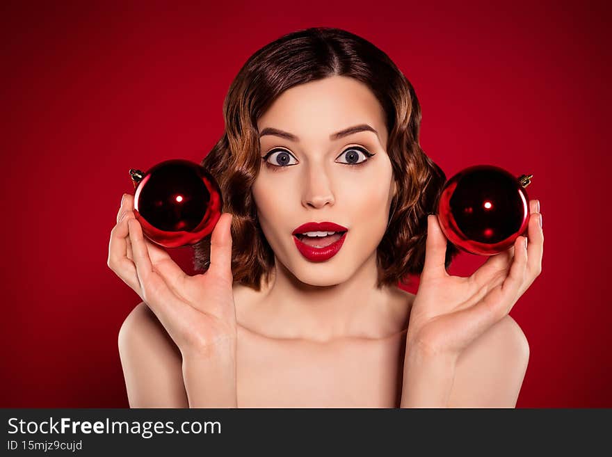 Photo of astonished funky model lady tender woman hold christmas decoration isolated on gradient red color background