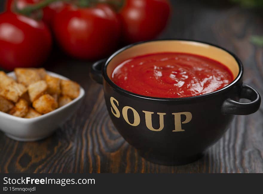 Tomato soup in a black bowl