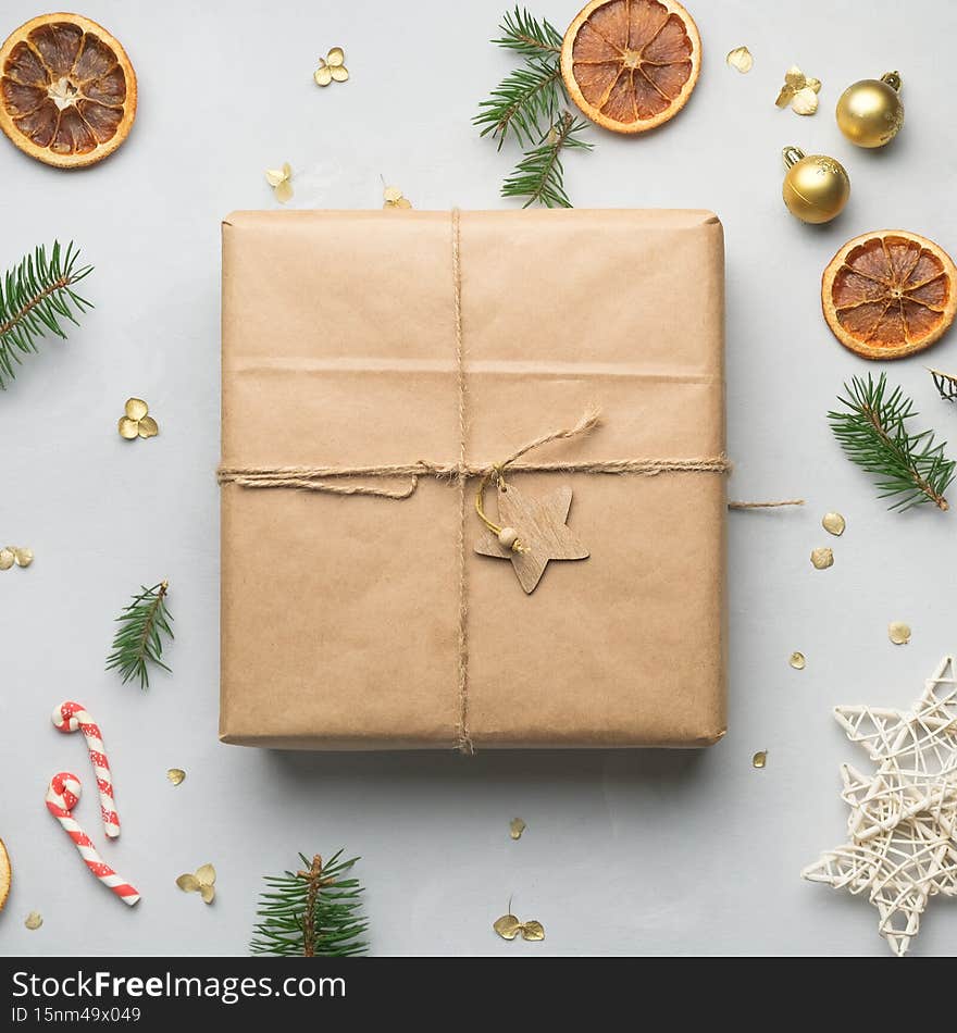 Christmas present. Parcel wrapped in brown paper and Christmas decoration. Box mockup, top view. Christmas present. Parcel wrapped in brown paper and Christmas decoration. Box mockup, top view.