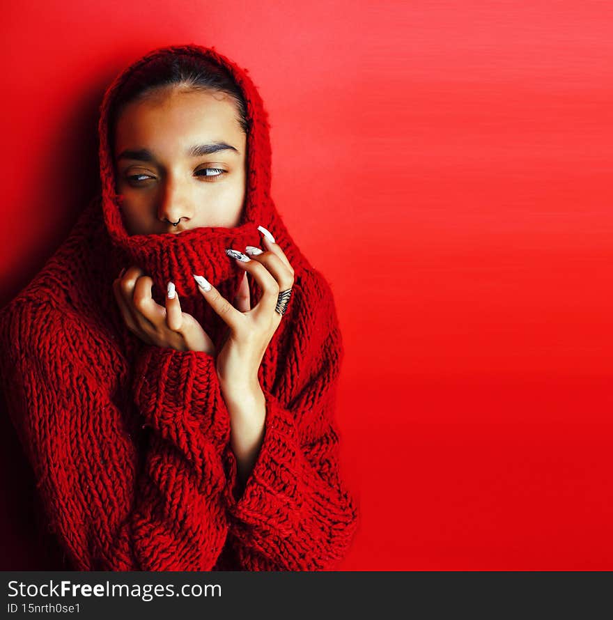 young pretty indian girl in red sweater posing emotional, fashion hipster teenage, lifestyle people concept