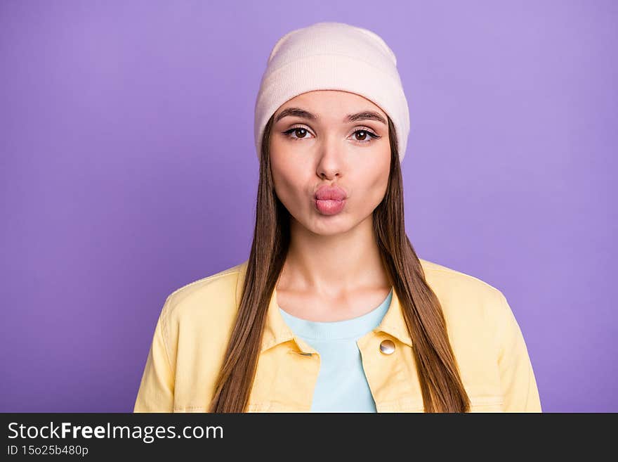 Portrait of optimistic straight hairdo girl blow kiss wear cap jacket isolated on purple color background.
