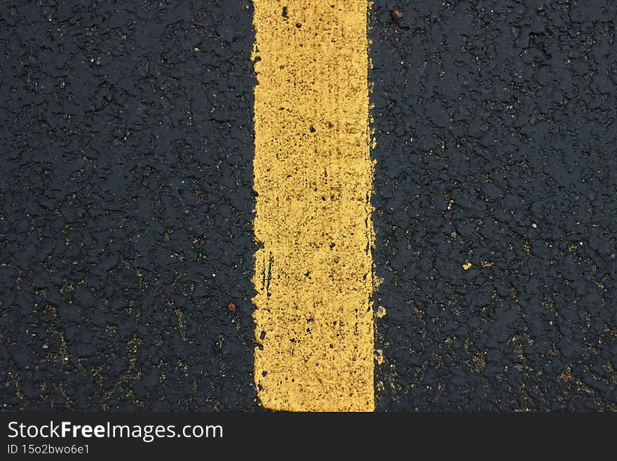 Surface grunge rough of asphalt Seamless tarmac dark grey with yellow line on the road and small rock Texture Background