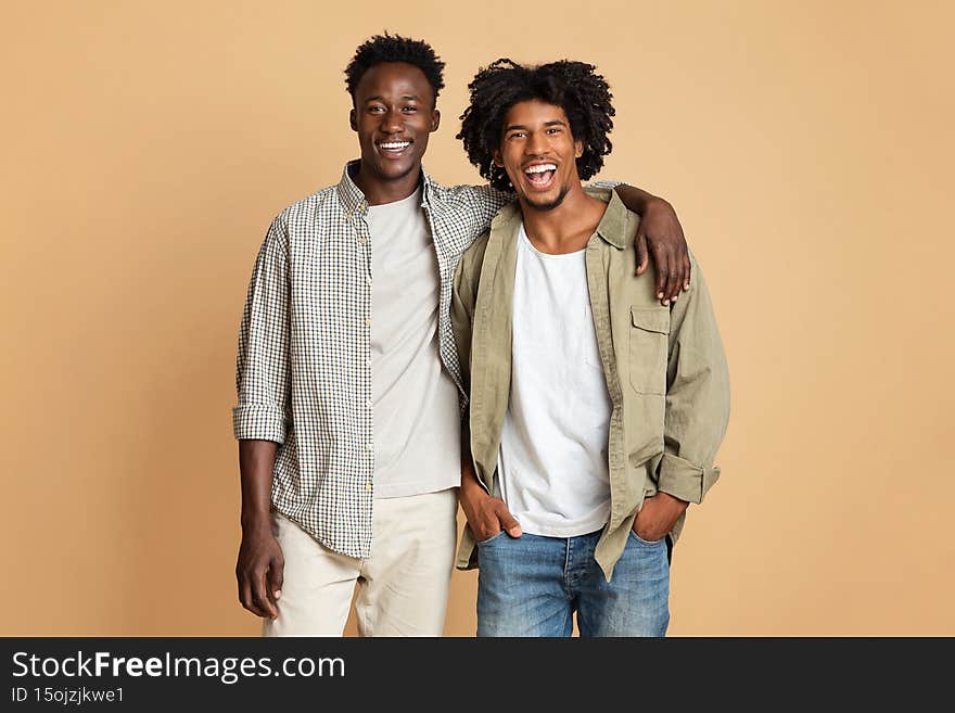 Male Friendship Concept. Two Happy Black Guys Embracing And Smiling At Camera