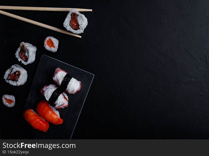 japanese sushi food. Maki ands rolls with tuna, salmon, shrimp, crab and avocado. Top view of assorted sushi.