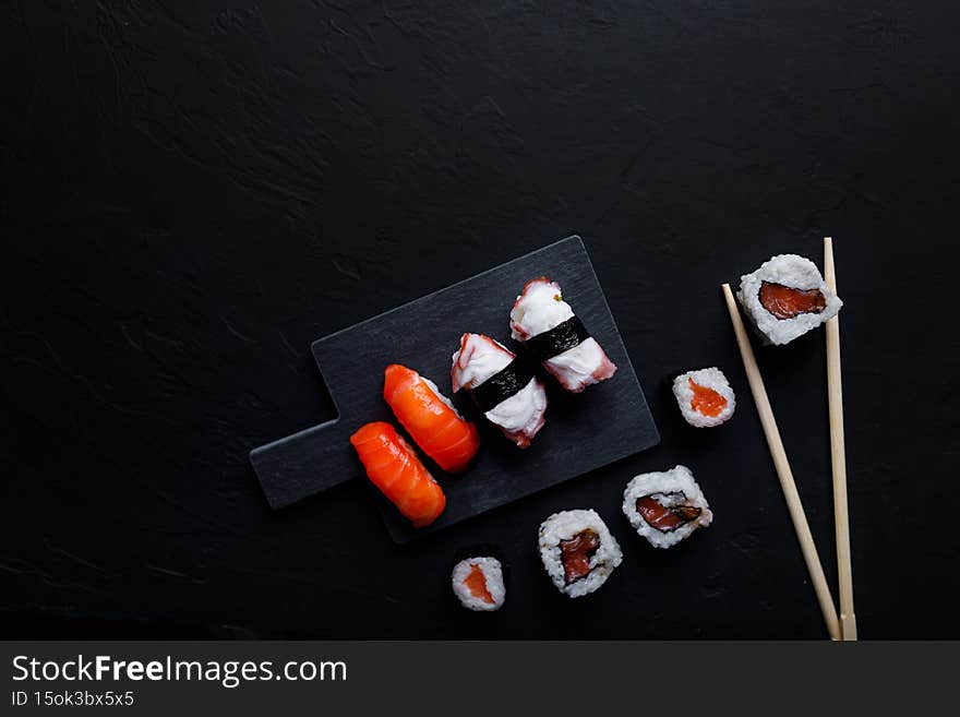 japanese sushi food. Maki ands rolls with tuna, salmon, shrimp, crab and avocado. Top view of assorted sushi.