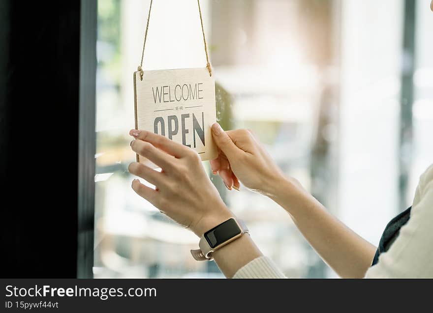Startup stores, small business owners Standing to display a sign at the reception for customers who will come to use the service in the shop after the coronavirus situation began to unfold
