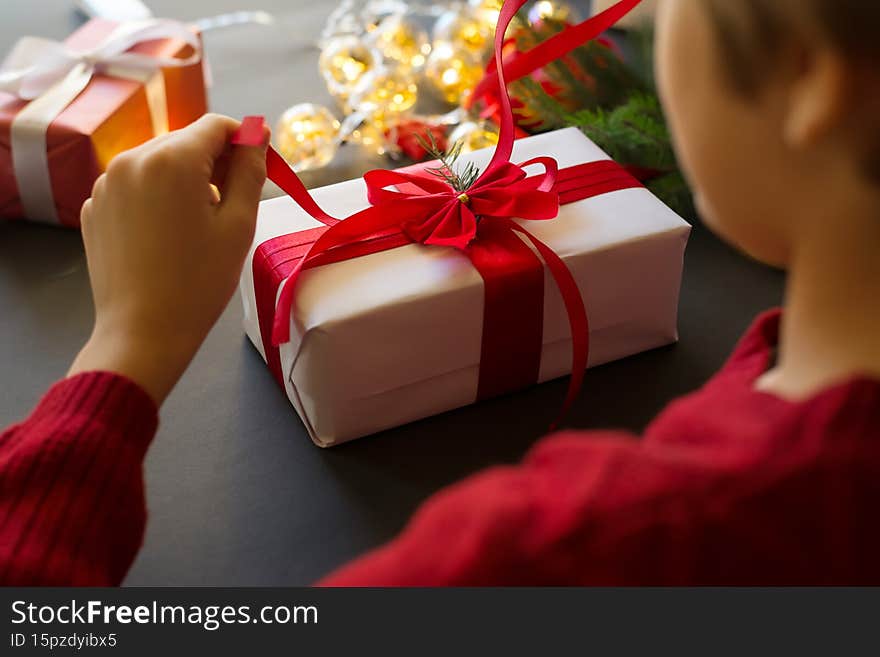 Boy preparing presents for Christmas or new year. Soft selective focus. Boy preparing presents for Christmas or new year. Soft selective focus.