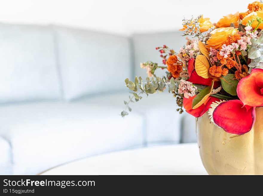 Floral arrangement of roses inside pumpkin decorated for a different Halloween. Floral arrangement of roses inside pumpkin decorated for a different Halloween