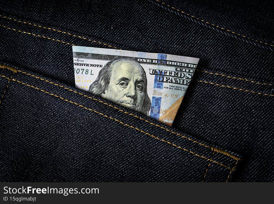Dollar banknote in a jeans pocket