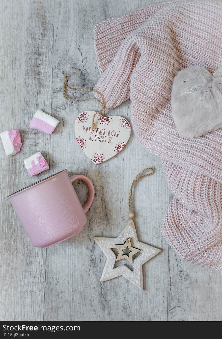Christmas decor in pink tones, pink cup with marshmallows, pink sweater