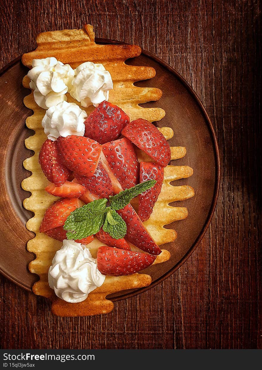 Strawberries with whipped cream on a waffle