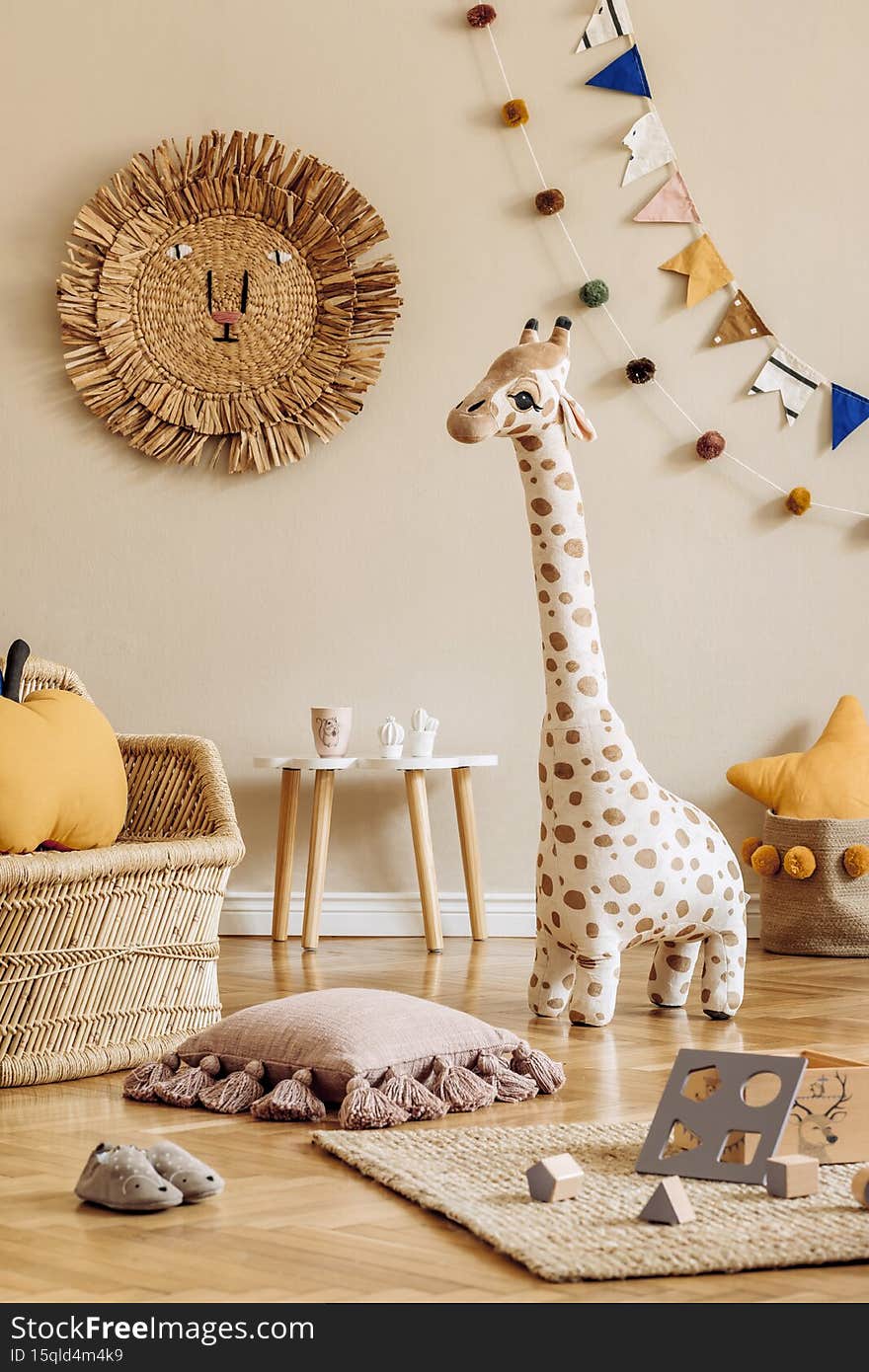 Stylish scandinavian interior of child room with natural toys, hanging decoration, design furniture, plush animals, teddy bears.