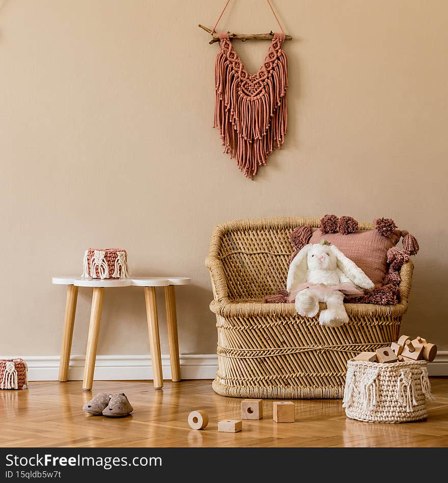 Stylish scandinavian interior of child room with natural toys, hanging decoration, design furniture, plush animals, teddy bears.