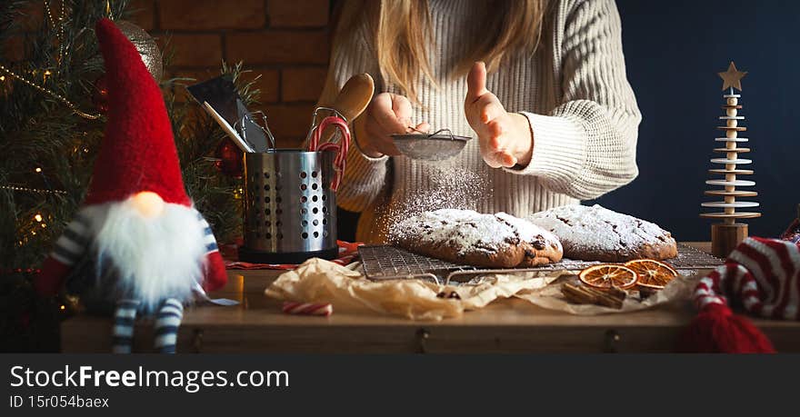 Christmas background. Table full of kitchen utensils and Christmas decoration. Homemade Christmas stollen bread Christstollen