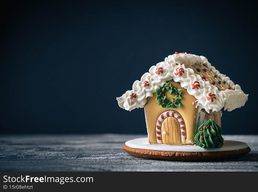 Christmas gingerbread house on the dark background with free space for text. Merry Christmas and Happy New Year 2022. Macro shot
