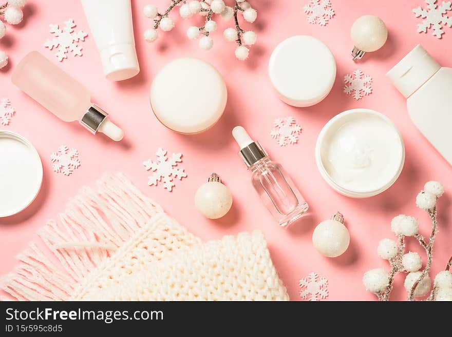 Winter cosmetic, skin care product on pink background.