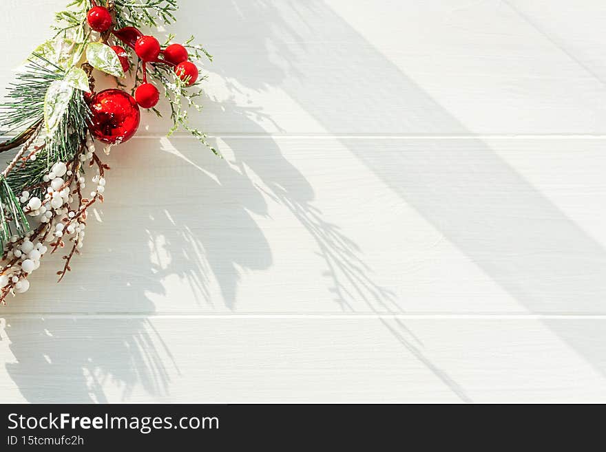 Christmas twig on a white wooden background