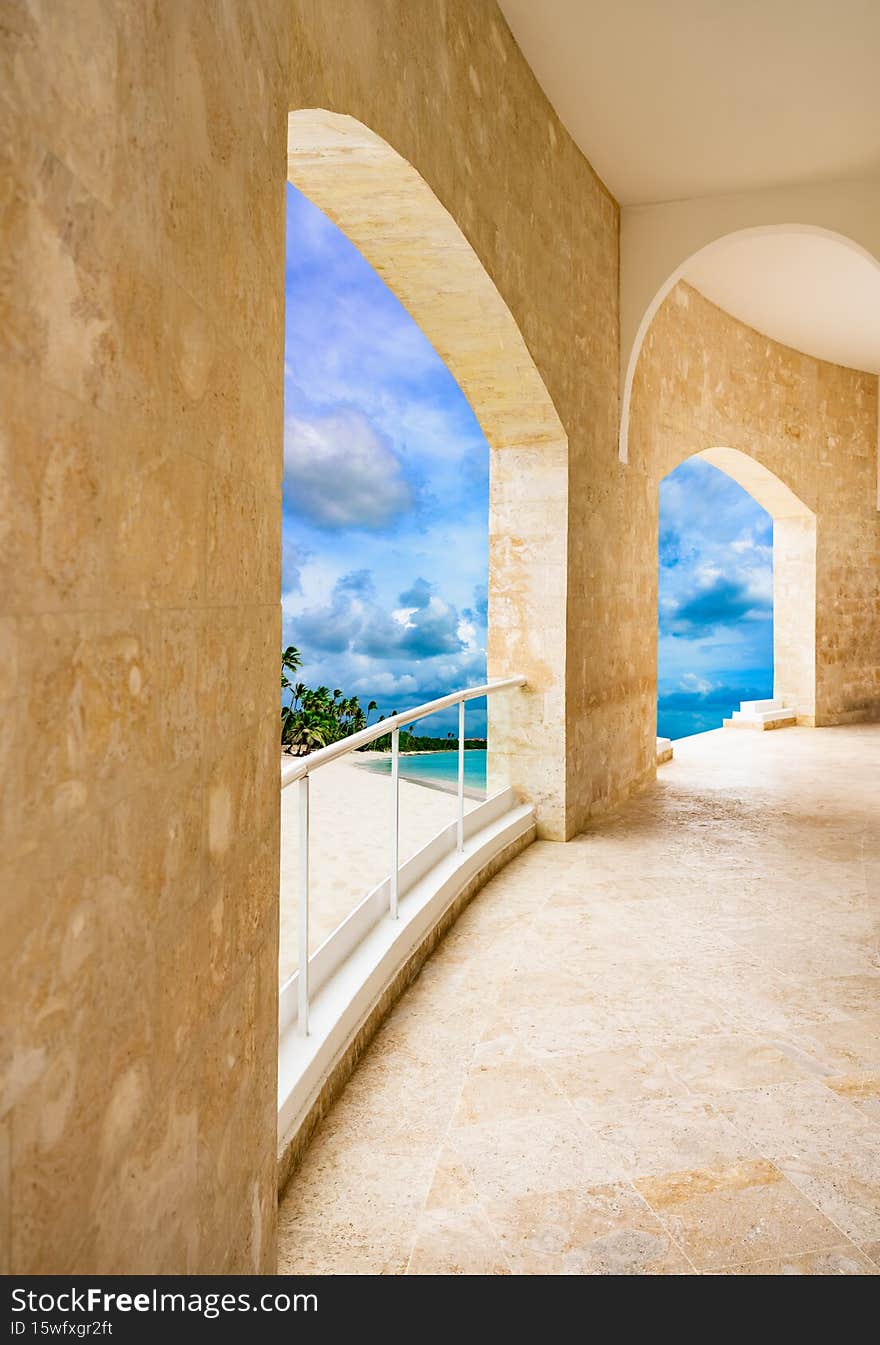 Open doorway arch door on the alley of palm trees on a sunny summer day. Open doorway arch door on the alley of palm trees on a sunny summer day
