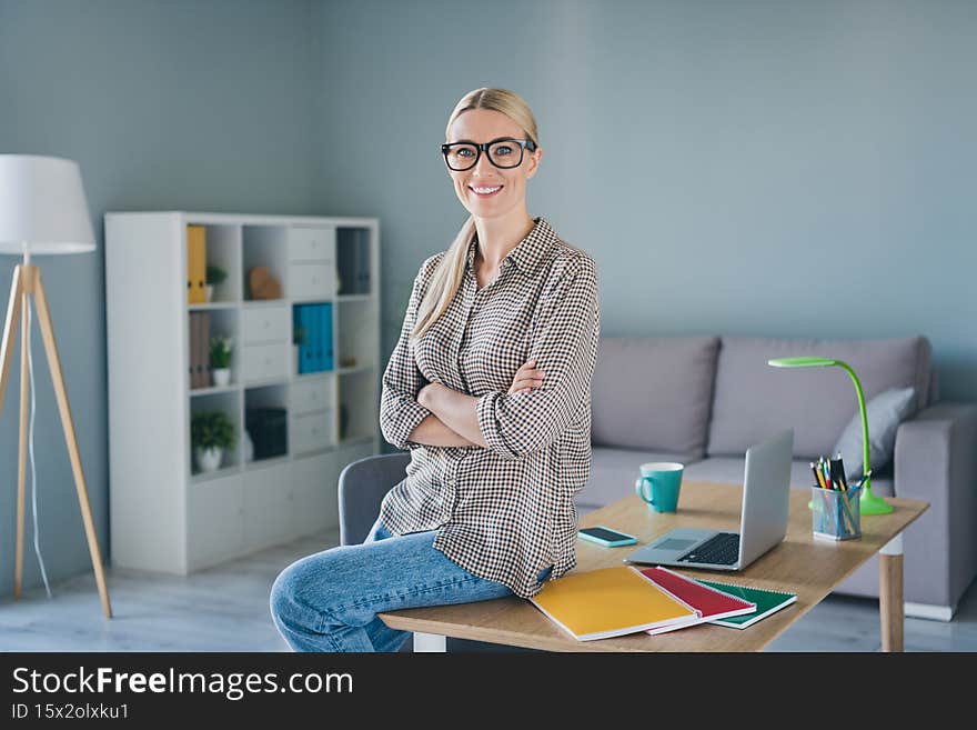 Photo of positive banker attorney economist lady sit table modern workspace cross arms enjoy company start up