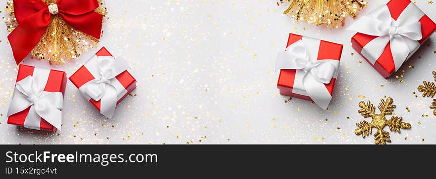 Celebratory white background with four gift boxes, Christmas toys. Christmas background with copyspace. Banner. Holiday concept