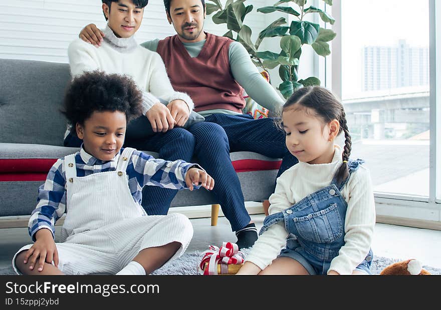 Selective focus little sweet happy diverse Caucasian and African girl and boy playing toys together, smiling in living room at