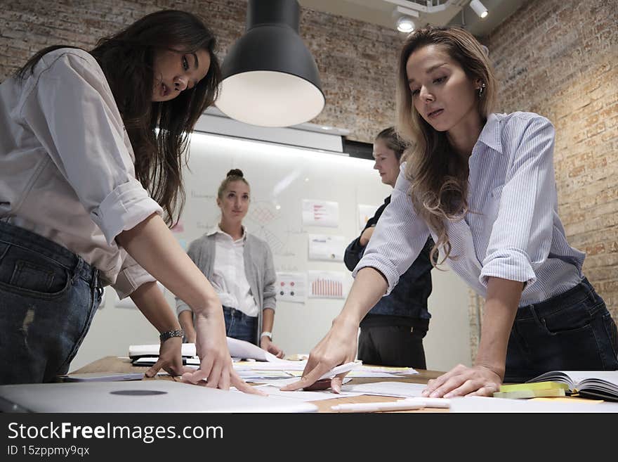 The coworker`s team and colleagues brainstormed, discussing in the meeting