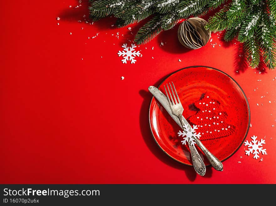Served Christmas table setting in red tones with vintage cutlery